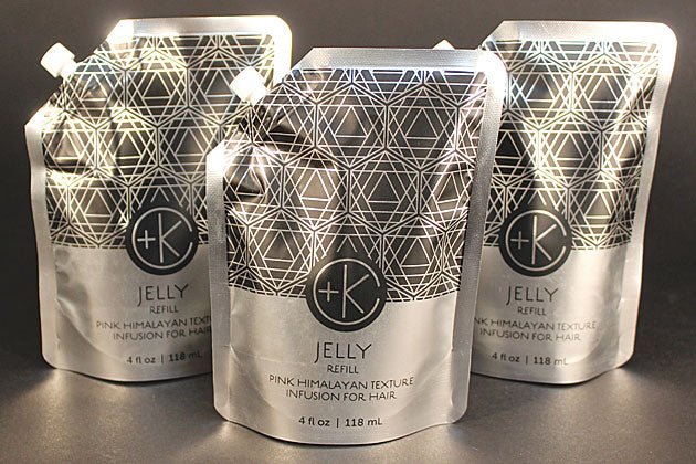 Three silver pouches labeled "Cult and King JELLY | Pink Himalayan Salt Infusion for Hair, 4 fl oz / 118 mL" are arranged on a dark background, promising to enhance volume and texture.