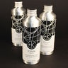 Three silver-toned bottles labeled "Cult and King TONIK | Conditioning Hair & Scalp Potion" are arranged on a dark surface. Each vegan, cruelty-free hair care bottle features a modern, abstract black and white design.
