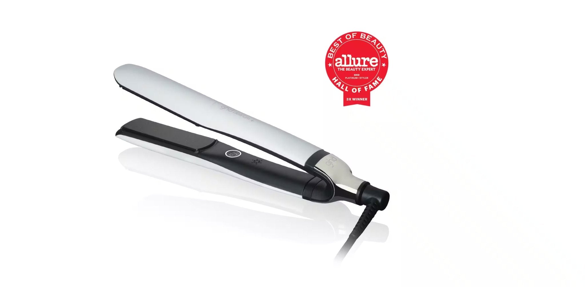 A GHD PLATINUM+ STYLER - 1" FLAT IRON with a silver top plate and a black bottom plate, featuring a red "Allure Best of Beauty Hall of Fame" award badge in the background, perfect for creating flat iron waves and personalized styling.
