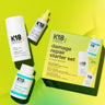 Image of K18 Hair Repair products against a gradient yellow-green background, featuring the K18 Damage Repair Starter Set, including a bottle of leave-in molecular repair hair mask, a bottle of peptide prep shampoo, and a bottle of hair oil. These vegan products harness the power of K18Peptide to reverse damage effectively.