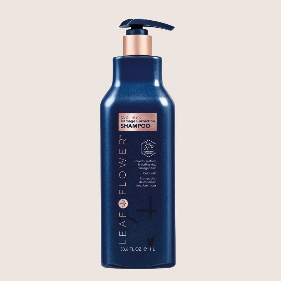 A 33.6 fl oz blue bottle of Leaf and Flower Damage Correction Shampoo with a pump top ensures color-safe restoration for damaged hair, offering frizz control and ultimate repair.