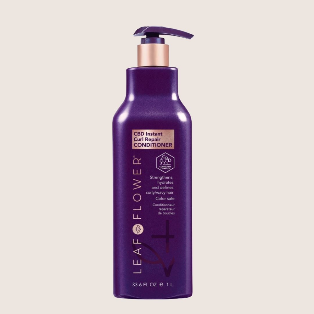 A 33.6 fl oz purple bottle of Leaf & Flower CBD Instant Curl Repair Conditioner with a pump dispenser. This vegan, color-safe formula works seamlessly with Leaf and Flower Instant Curl Refresh Shampoo to effortlessly rejuvenate and protect your curls.