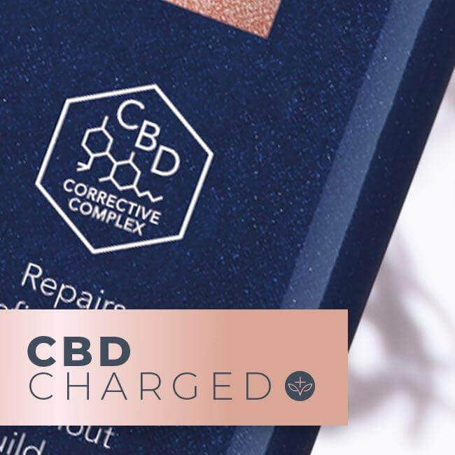 Close-up of a product label with the words "CBD Charged" and "CBD Corrective Complex" alongside a chemical structure illustration. The label, advertising the LEAF and FLOWER Instant Volume Conditioner, has a dark blue background with white text.
